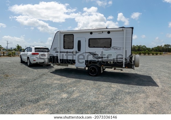 Proserpine, Queensland, Australia - November\
2021: Car and caravan parked at coffee plantation to have a break\
on the journey