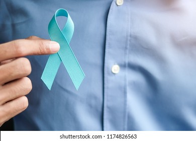 Prostate Cancer Awareness, Man holding light Blue Ribbon for supporting people living and illness. Men Healthcare and World cancer day concept - Powered by Shutterstock