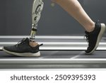 prosthetic, artificial leg. Woman with prosthetic leg using walking on treadmill while working out in gym. artificial leg. Woman wearing prosthetic equipment sit down after exercising in gym.	
