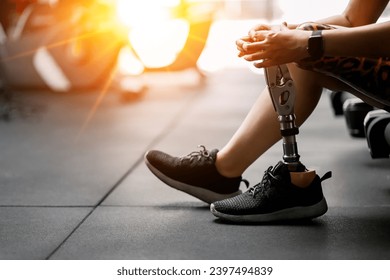 prosthetic, artificial leg. Woman with prosthetic leg using walking on treadmill while working out in gym. artificial leg. Woman wearing prosthetic equipment sit down after exercising  in gym. - Powered by Shutterstock