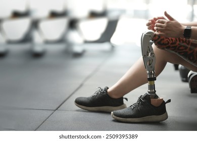 prosthetic, artificial leg. Woman with prosthetic leg using walking on treadmill while working out in gym. artificial leg. Woman wearing prosthetic equipment sit down after exercising in gym.	
 - Powered by Shutterstock