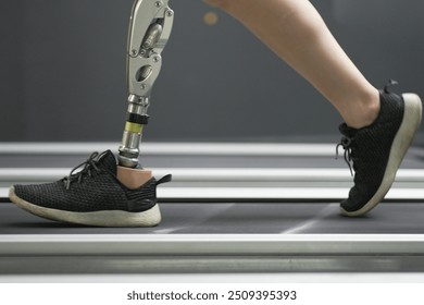 prosthetic, artificial leg. Woman with prosthetic leg using walking on treadmill while working out in gym. artificial leg. Woman wearing prosthetic equipment sit down after exercising in gym.	
