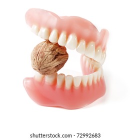 Prosthetic bridge with new strong teeth biting hard nut on white background