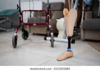 Prosthetic leg standing in a rehabilitation center alongside a walker, symbolizing recovery and mobility support through modern assistive technology in healthcare. - Powered by Shutterstock