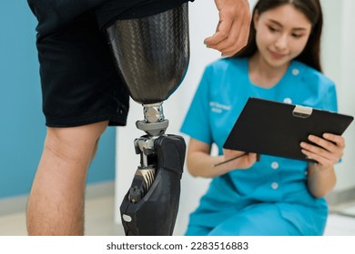 Prosthetist nurse checking prosthetic leg of patient at health care - Powered by Shutterstock