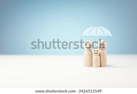 Protect and care for your family, umbrella above a family cover and shelter wooden people, security, protection, finance or insurance concept