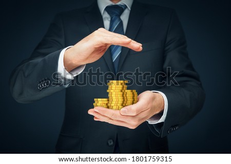 Protect investments and savings, financial insurance concept. Businessman hand with protective gesture and coins of money.