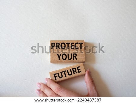 Protect your future symbol. Concept words Protect your future on wooden blocks. Beautiful white background. Businessman hand. Business and Protect your future concept. Copy space.