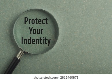 Protect your identity message displayed through a magnifying glass. Concept for identity theft prevention, personal data security, privacy protection, cybersecurity and online safety awareness.