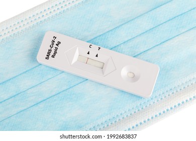 Protect Yourself. Negative Covid Test. Covid-19 Has Not Been Detected. Rapid Test On A Protective Medical Mask On A White Background. SARS-CoV-2 Ag Rapid Antibody Test. Nasopharyngeal Swab. Close Up.