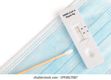 Protect Yourself. Negative Covid Test. Covid-19 Has Not Been Detected. Rapid Test On A Protective Medical Mask On A White Background. SARS-CoV-2 Ag Rapid Antibody Test Kit. Nasopharyngeal Swab.