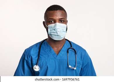 Protect Yourself. Portrait Of Confident Black Doctor In Face Mask Over White Studio Background, Copy Space