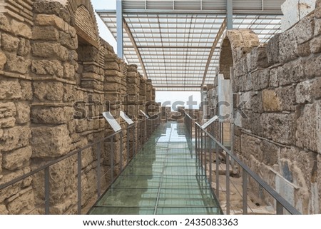 Protected Laodicea church ruins, glass walkway, stone walls, informational signs, modern canopy. Denizli, Turkey (Turkiye)