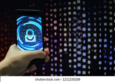 protected in stream of data flow. padlock icon symbolic security and motion movement of binary code computer data moving in the background. hand holding mobile phone.