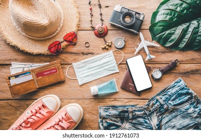 Protecting COVID-19 while Traveling. Travel accessories costumes. Passports, luggage, The cost of travel maps prepared for the trip .concept new normal lifestyle