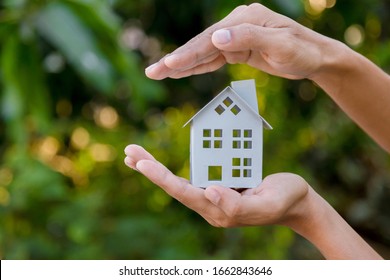 Protecting gesture of man and symbol of house. - Shutterstock ID 1662843646
