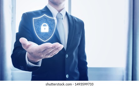 Protection Business Network And Digital Data. Businessman Holding Shield With Lock Icon