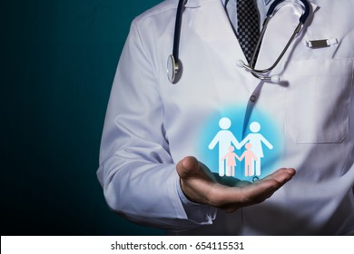 Protection of the family and marriage. Family Care Health Centers. The doctor is holding a pictogram of a family with children in his hand.