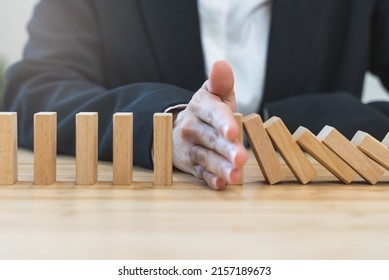 Protection Finance From Domino Effect Concept. Hands Stop Domino Effect Before Destroy Stack Of Money.