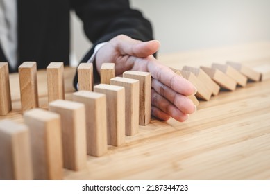 Protection Finance From Domino Effect Concept. Hands Stop Domino Effect Before Destroy Stack Of Money.