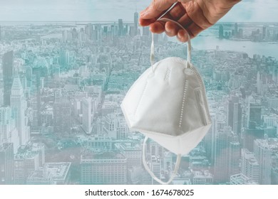 Protection Mask N-95 In Hand  With New York City Skyline Background. Prevention Of The Spread Of Virus And Epidemic, Social Issues, Diseases, Flu, Air Pollution, Corona Virus Concept