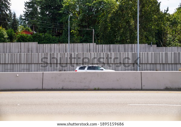 Protection of residents against noise generated\
by car traffic and separation of lanes. Concrete acoustic barriers\
decorated with a structural pattern.\
