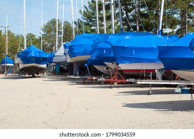 Protective Blue Tarp On Boats In Michigan Outdoor Storage Lot