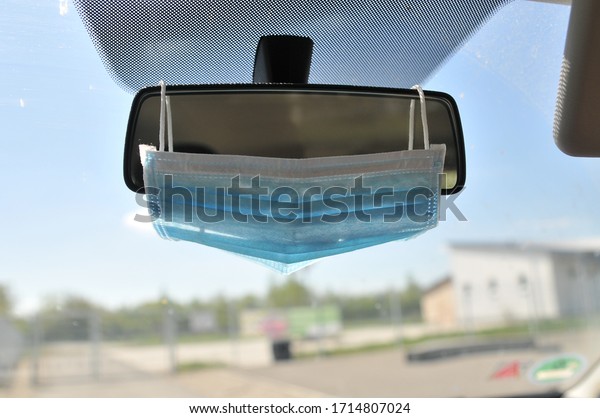 Protective face mask on car mirror because of\
mask obligation in\
germany