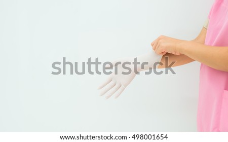 protective gloves isolated on white background,Doctor or nurse putting on protective gloves, on light background,woman surgeon doctor wear glove before operation,Medical gloves