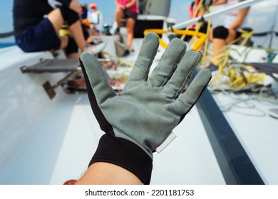 protective gloves for working on a sailing yacht. gloves for working with sea rope. protected hands of a man on a boat