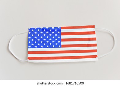 Protective medical mask with the flag of USA. Concept symbol of closing state borders and pandemic control