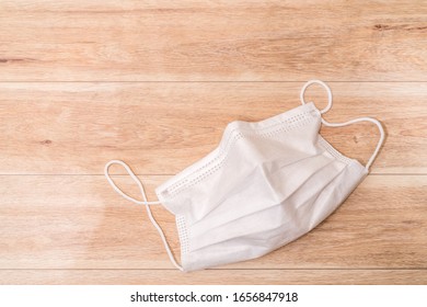 Protective Medical Mask On Wood Table Background.