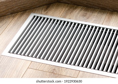 Protective radiator grille built into the floor for heating panoramic windows. Heating grid with ventilation by the floor in hardwood flooring