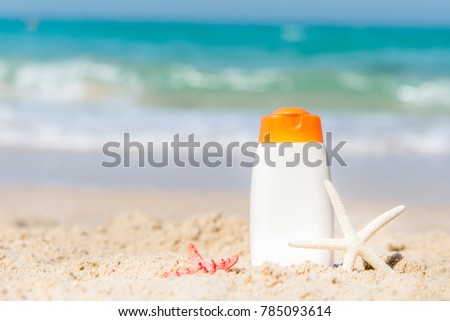 Protective sunscreen or sunblock and sunbath lotion in white plastic bottles on tropical beach, summer accessories in holiday, copy space.  Summer Concept