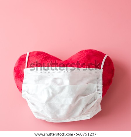 Protective white face mask on pink background, copyspace.