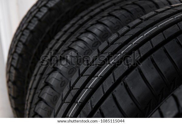 Protector of automobile tires. A number\
of automobile tires. Close up view on auto mobile new wheel tire\
surface. Different pattern and type tires for car industry\
commercial transport\
transpotration.