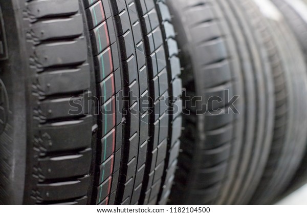 Protector of automobile tires. A number
of automobile tires. Close up view on auto mobile new wheel tire
surface. Different pattern and type tires for car industry
commercial transport
transpotration.