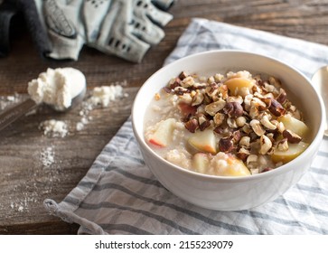 Protein Breakfast Bowl With Porridge. Cooked With Whey Protein Powder And Apples. Served With Roasted Hazelnuts 