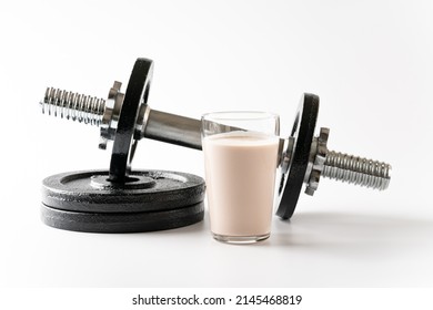 Protein Drink And Dumbbells On White Background.