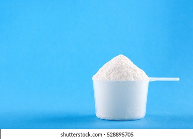 protein powder in a plastic spoon