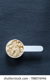 Protein Powder Scoop Against Slate Background