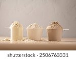 Protein powder in scoops. Different flavours of whey protein powder, copy space.