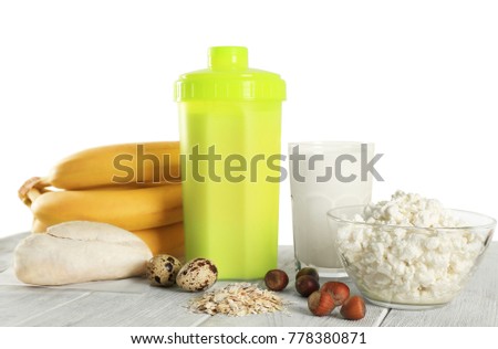 Protein shake in bottle and products on table