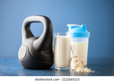 Protein Sport Shake And Weight On Blue Background . Fitness Food And Drink. Diet. Copy Space