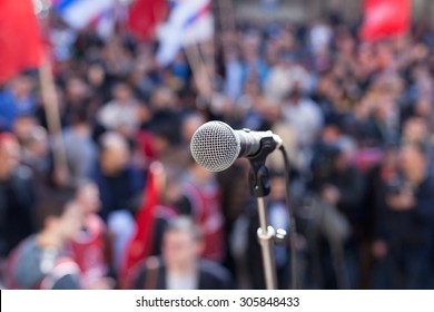 Protest. Public demonstration. Microphone in focus against blurred audience. - Shutterstock ID 305848433