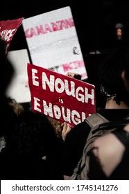 Protest Sign 'Enough Is Enough. Protest Sign Against Police Brutality Held Up In A Crowd. Red Protest Sign. Activist Holding A Sign At Protest