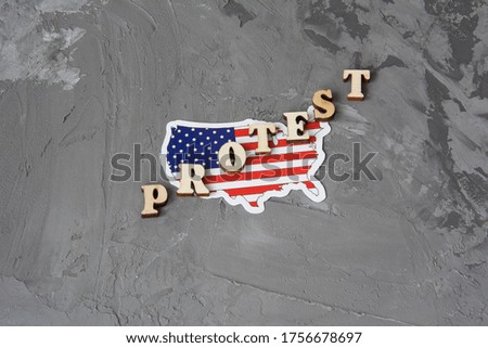Protest sign flat lay on a gray background with american flag.