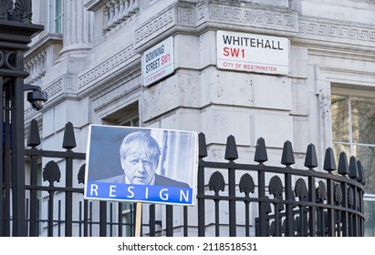 A protest sign outside the gates of Downing Street with a picture of Boris Johnson with the word Resign below. Focus on sign. London - 5th February 2022