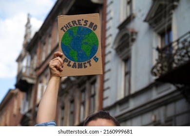 Protester holding sign with slogan There's no planet B. Woman with placard at protest rally demonstration, strike against global warming and climate change. - Shutterstock ID 2160999681