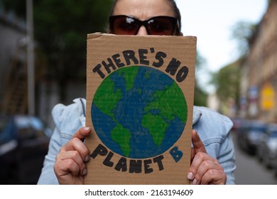 Protester Holding Sign With Slogan There's No Planet B. Woman With Placard At Protest Rally Demonstration, Strike Against Global Warming And Climate Change.